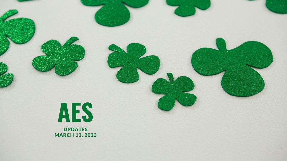 image of green cut out clovers with text of AES updates, March 12, 2023