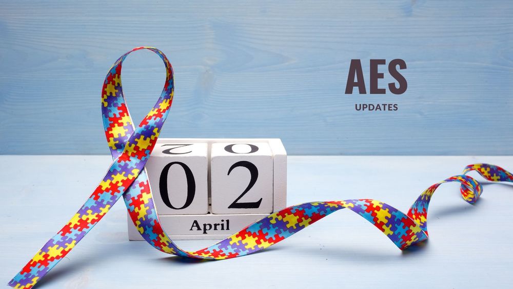 image of a ribbon with colored puzzle pieces on it and text of AES updates, April 2
