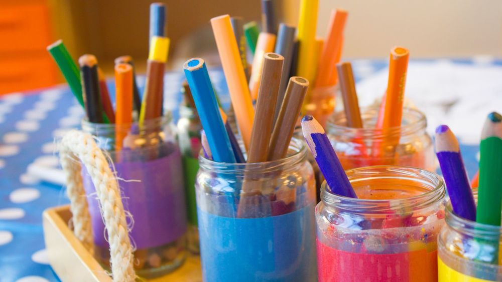 image of colored pencils in color coded jars